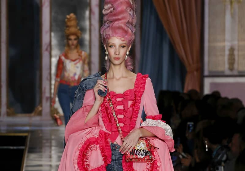 Model in tall pink wig and ornate pink gown walks runway at Moschino fashion show during Milan Fashion Week