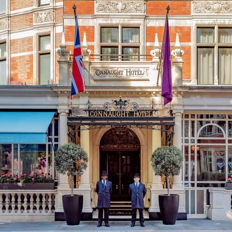 The grand entrance of The Connaught, with uniformed doormen, classic architecture, and refined elegance in the heart of Mayfair.