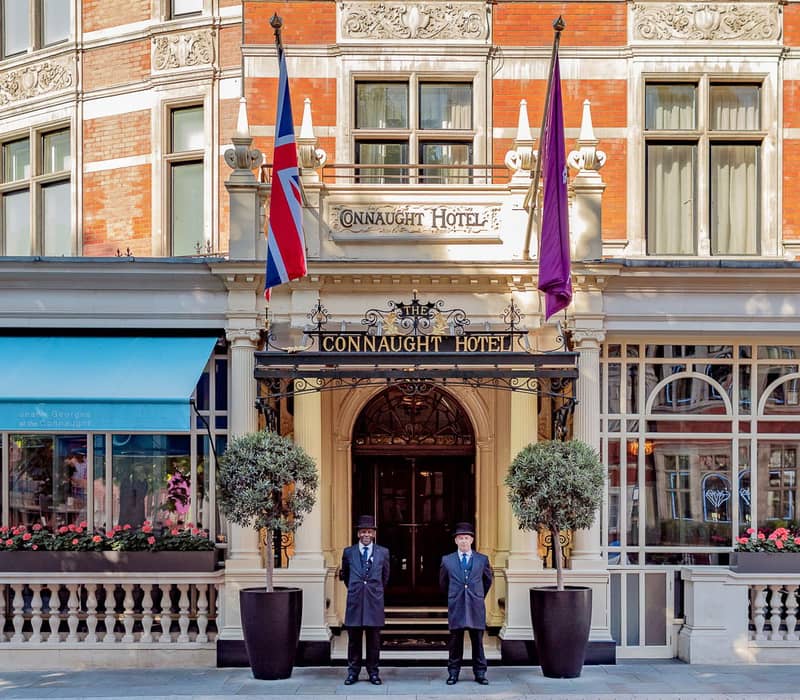 The grand entrance of The Connaught, with uniformed doormen, classic architecture, and refined elegance in the heart of Mayfair.