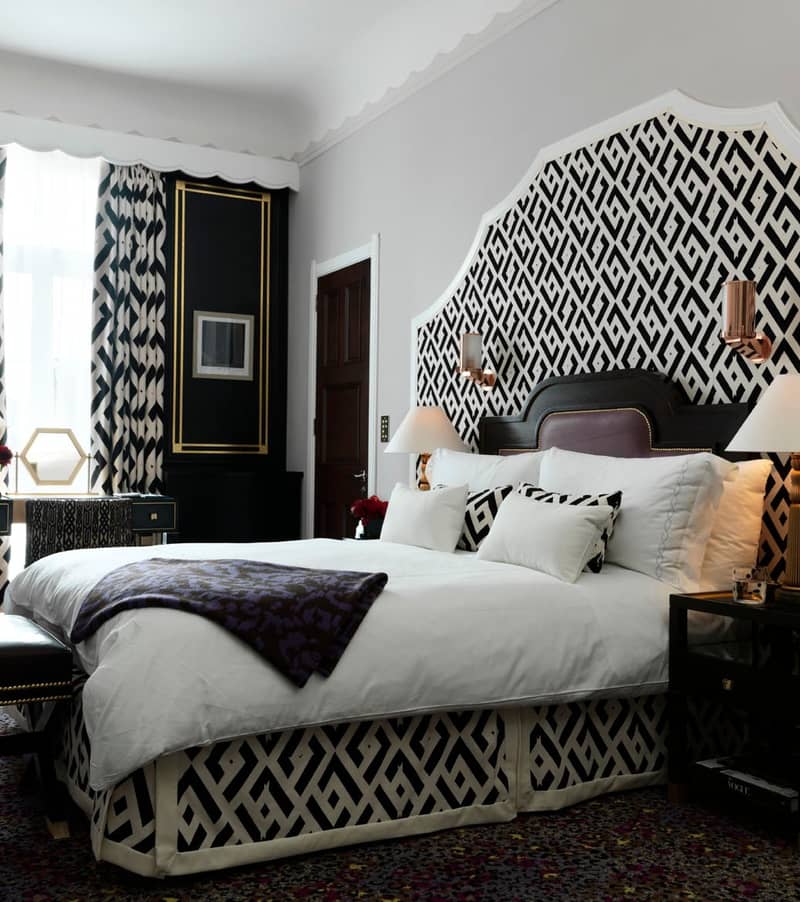 Bold black and white geometric bedroom design, featuring luxurious bedding, intricate patterns, and elegant decor.