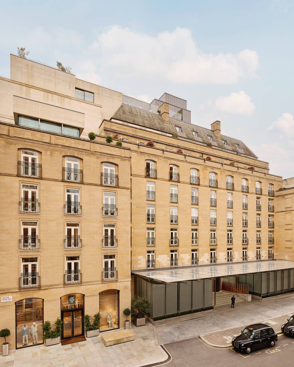 The Berkeley's stately exterior, featuring classic stone architecture, wrought-iron balconies, and a sophisticated entrance with glass canopies in Knightsbridge.