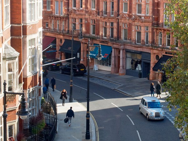 The street view of the red brick buildings of Mayfair from the Connaught