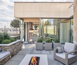 Penthouse Suite at The Berkeley - rooftop terrace with fireplace, couches and view onto the suite and rooftops of London.