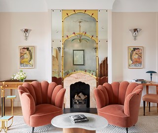 Mayfair Suite at Claridges - two pink armchairs with fireplace in the background and artwork on the walls.
