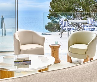 Duplex Pool Suite at The Maybourne Riviera - coffee table with sofa and view on the terrace with table, chairs and pool on the terrace with view onto the sea.