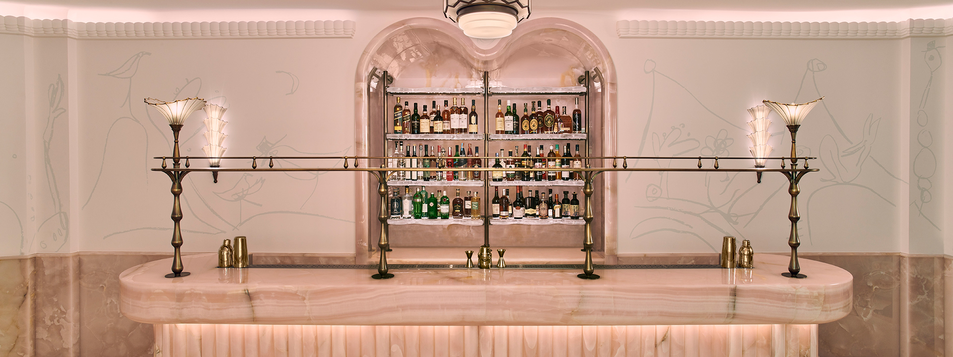 An image of The Painter's Room Bar at Claridge's in London. The image shows the bar and shelves of alcohol behind in. 
