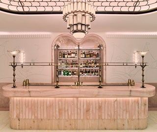 The Painter's Room at Claridge's. Image shows interior of the bar with well stocked shelves of alcohol behind it.