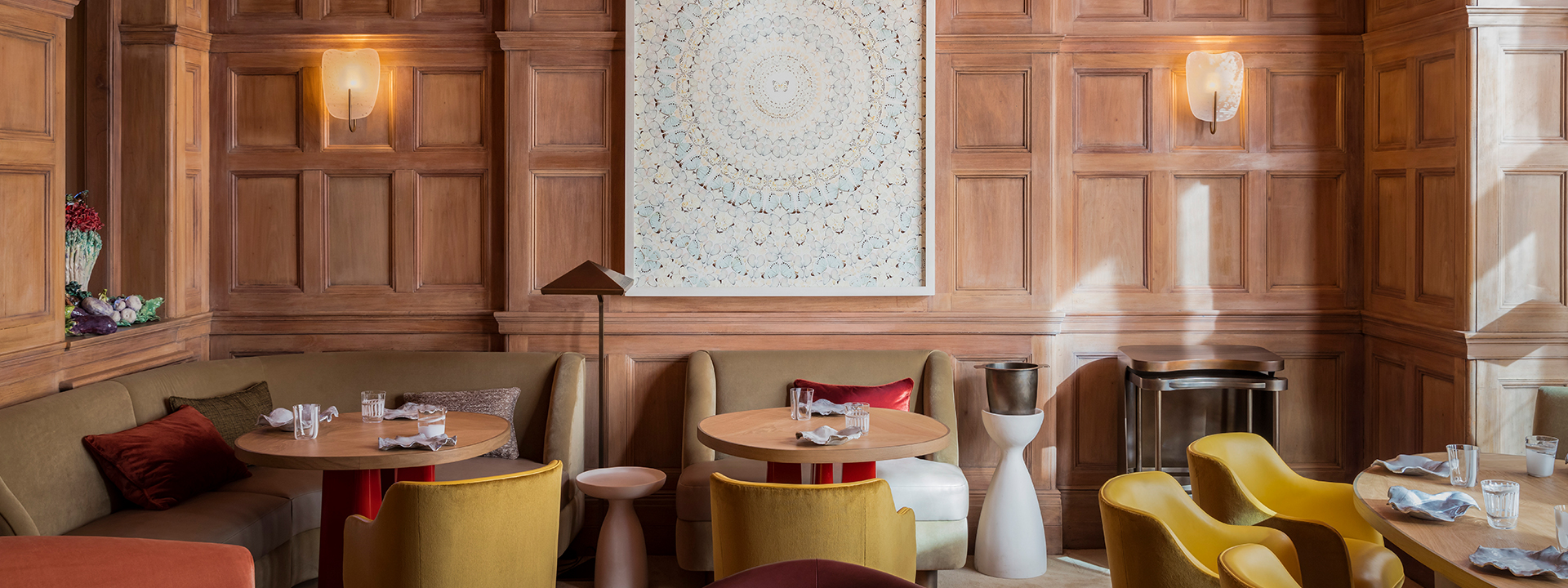 Hélène Darroze at The Connaught - restaurant room with tables set up and artwork on the wall.n