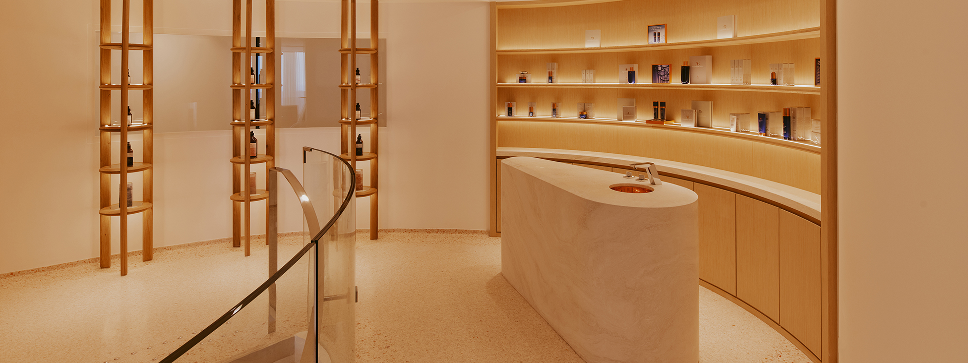 The Maybourne Riviera Spa Entrance Counter with product on shelves one each side of the counter